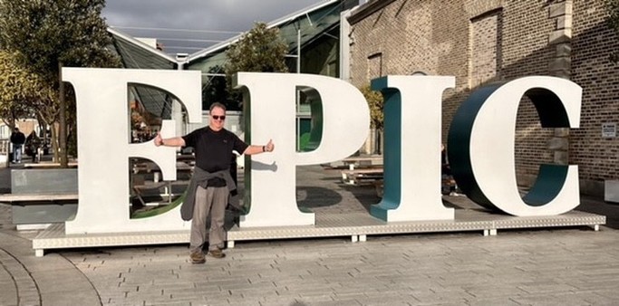 Futurist Jim Carroll in front of a sign in Dublin that says, simply, "EPIC"