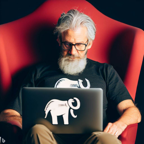 AI image prompt: "a man sitting in a red chair, with a laptop. On the screen, which can be seen, is the Mastodon elephant logo. The man has gray hair and wrinkles on his face"