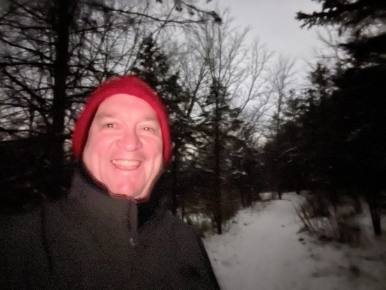 A picture of futurist Jim Carroll out for his morning walk in the snow, with a big booby smile on his face