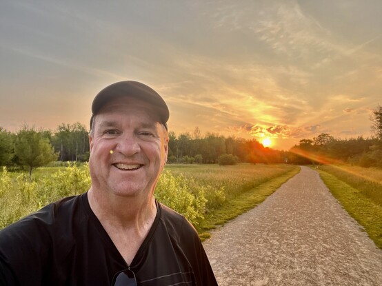 A picture of Jim Carroll with the sun rise in the background