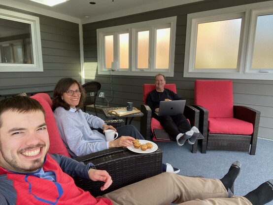 Jim Carroll with his wife and oldest son in an outdoor 3 season sun room.