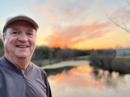 Futurist Jim Carroll out on his morning walk with a beautiful sunrise over a pond