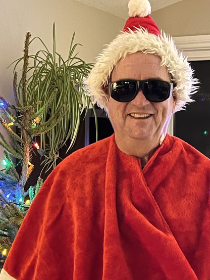 Futurist Jim Carroll will bigass dark glasses, a Santa hat and red cape.