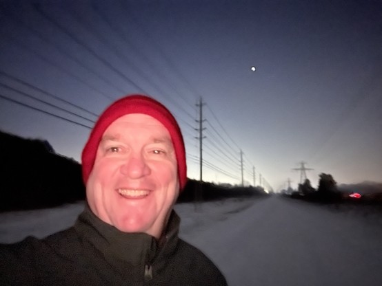 Futurist Jim Carroll over his morning walk with his big goofy smile. In the distance is a hint of a sunrise and Venus in the sky.