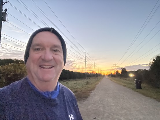 A picture of Jim Carroll with the morning sunrise